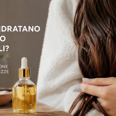 Donna con capelli lunghi castani e bagnati che utilizza un olio per capelli sulle lunghezze, immagine beauty haircare dedicata all’idratazione dei capelli, alla cura della fibra capillare e al trattamento dei capelli secchi, crespi e sfibrati. Editoriale cosmetico sugli oli per capelli, idratazione e nutrimento delle lunghezze, olio capelli secchi, trattamento capelli danneggiati, hair oil, cura delle punte e haircare routine.